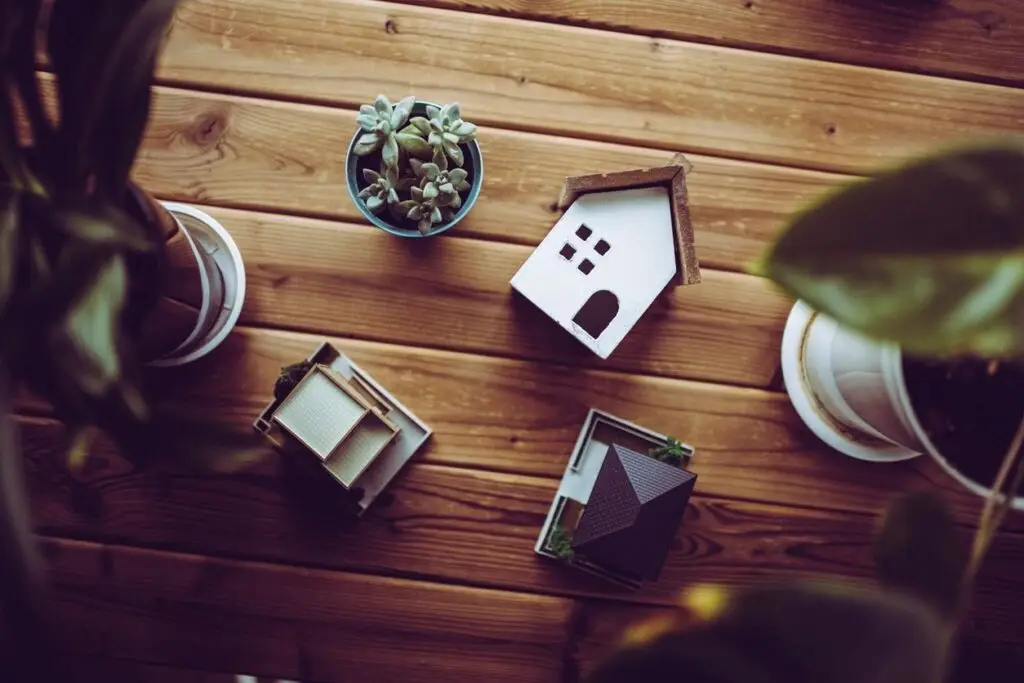 Miniature items of wood table with a small home as well