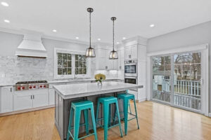 White shaker cabinets with gray island.